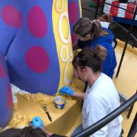 Women painting parade float
